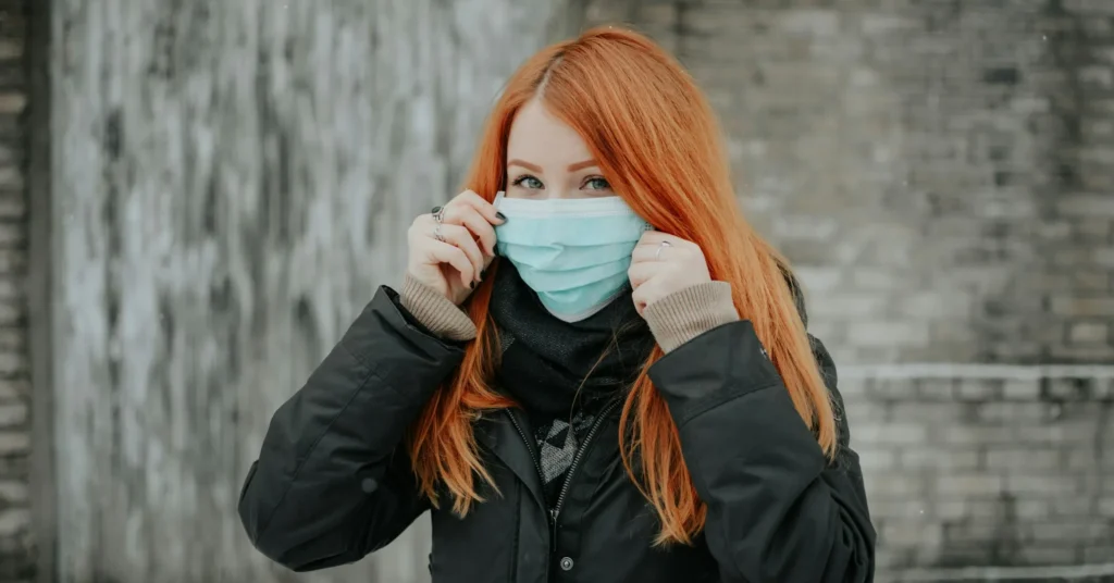 A girl wearing a mask to avoid the spread of infection.